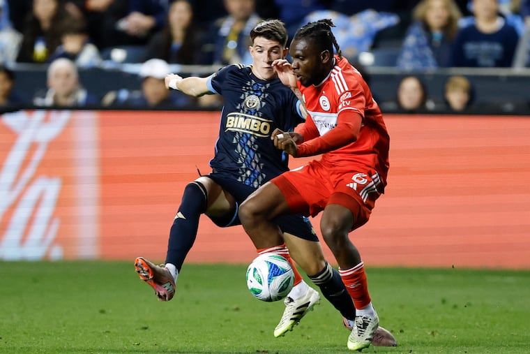 Jovan Lukić battling Chicago midfielder Rominigue Kouamé during Game 1 of their playoff series.