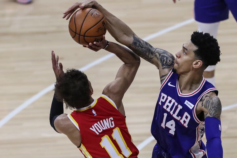 The Sixers' Danny Green blocking the pass of Hawks guard Trae Young on April 30 at the Wells Fargo Center.