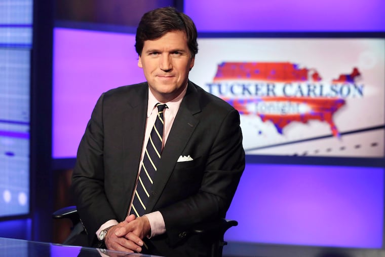 Tucker Carlson, host of "Tucker Carlson Tonight," poses for photos in a Fox News Channel studio in 2017 in New York.