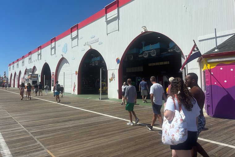 People walk past the old Gillian's Wonderland Pier at 600 Boardwalk in Ocean City, N.J. on Aug. 30, 2025. The defunct amusement park now houses a small arcade, pizza shop and bagel store. An idea for a 7 story hotel was shot down by City Council.