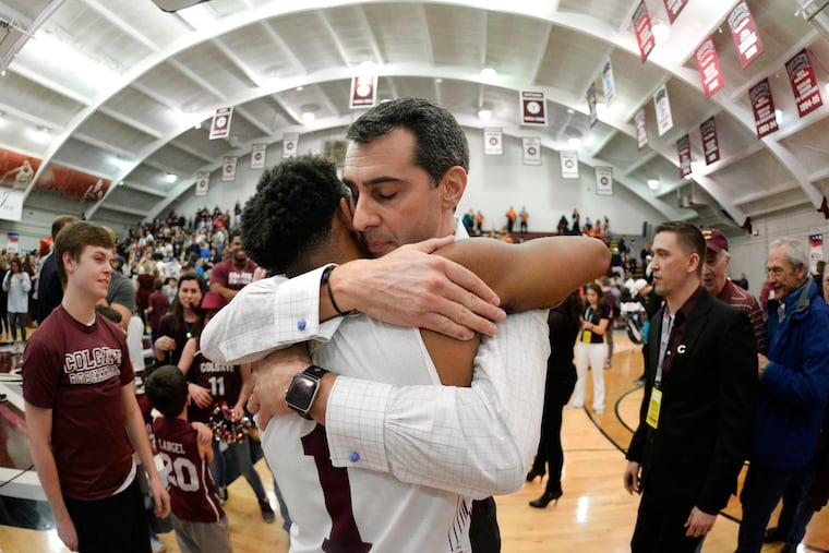 Colgate coach Matt Langel hugs guard Jordan Burns after the team's win against Bucknell in an NCAA college basketball game for the championship of the Patriot League men's tournament in Hamilton, N.Y., Wednesday, March 13, 2019. Colgate won 94-80. (AP Photo/Adrian Kraus)