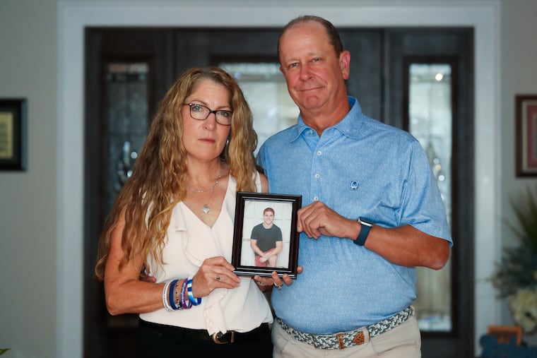 Evelyn and Jim Piazza hold a picture of their son Tim who died after a hazing incident in 2017 at a Penn State fraternity.