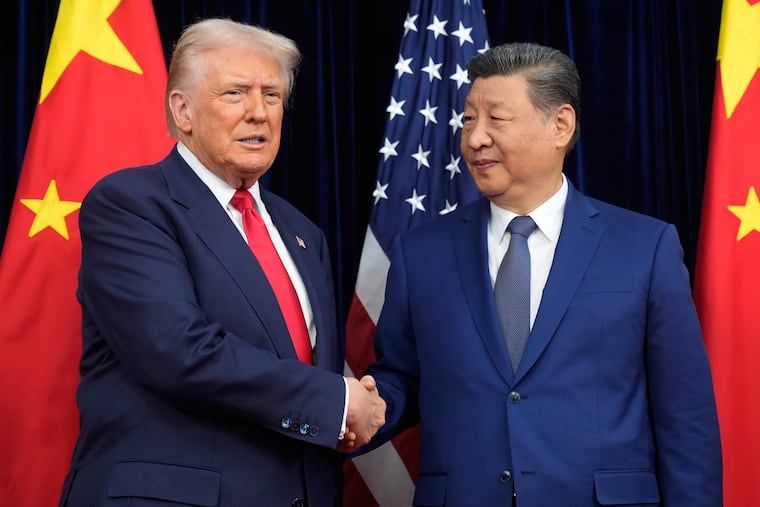 FILE - President Donald Trump, left, and Chinese President Xi Jinping shake hands before their meeting at Gimhae International Airport in Busan, South Korea, Oct. 30, 2025.