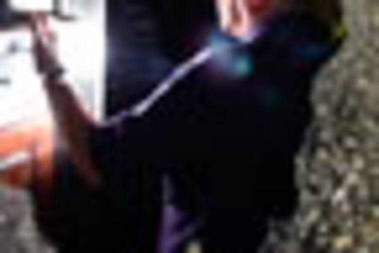 An investigator is seen through a bullet shattered front door window after a two year-old was shot in the stomach on the 4600 block of north 12th Street in the Logan section of Philadelphia around 9:30 p.m., Saturday June 16, 2012. A large block party to celebrate Father's Day weekend and about 200 people were on the street and that a second victim was hit in the leg, and third man shot in the hand. The men are expected to be okay, but the toddler is in critical condition at Einstein, police said.
(For the Daily News/ Joseph Kaczmarek)