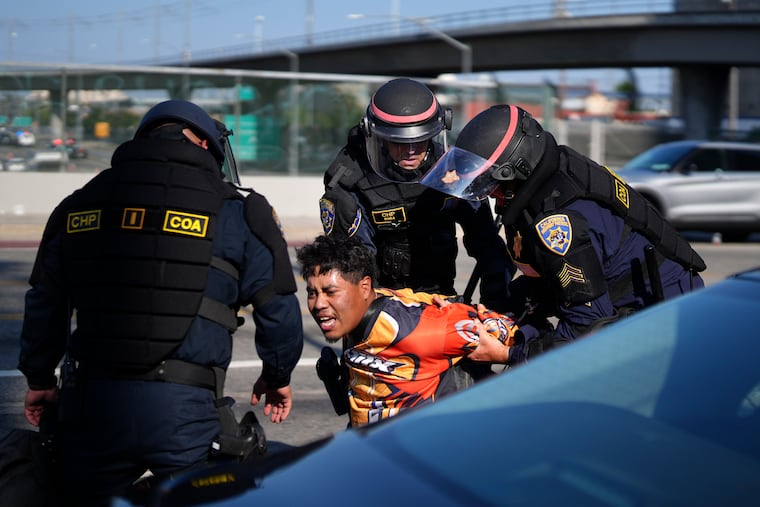 A protester is arrested by California Highway Patrol near the federal building in downtown Los Angeles on Tuesday, June 10, 2025.