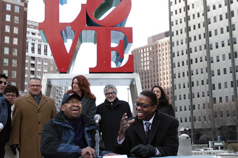 Mayor Michael Nutter, left, and Council President Darrell L. Clarke, right, reached an agreement that would allow the rehab of JFK Plaza and the sale of the garage beneath LOVE Park to move ahead. Mayor Nutter laughs as Clarke said it was his worst signature because it was so cold as the two signed a document that outlined their "shared vision for LOVE Park" in Philadelphia, Pa. on February 9, 2014. ( DAVID MAIALETTI / Staff Photographer )