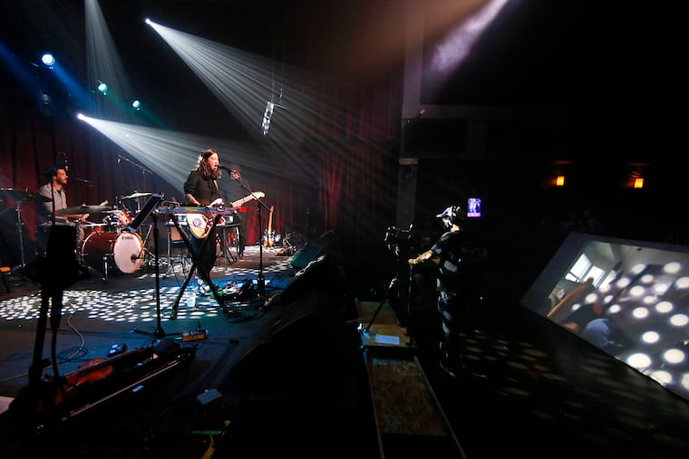 Michelle Zauner of Japanese Breakfast (left) sings as she faces the zoom audience being projected onto a screen for the performers to see (right) during the first night of the Philly Music Fest at the Ardmore Music Hall in Ardmore, Pa. on Sept. 24, 2020.