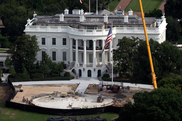 Construction crews work on a new helipad on the South Lawn of the White House on Tuesday.
