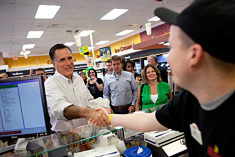 Mitt Romney shakes hands and orders a sandwich at a Quakertown Wawa. The candidate's small-town bus tour brought him to Bucks County, but the presence of 250 protesters at his scheduled stop chased him to a different store. EVAN VUCCI / AP