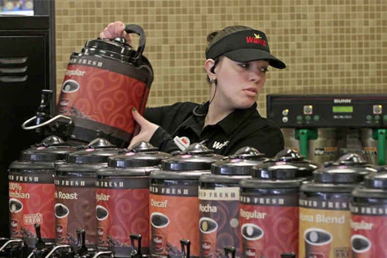Jamie Vasquez, Wawa assistant manager, changes a coffee carafe at a new Wawa in the Northeast, at 9307 Krewstown Rd. MICHAEL BRYANT / Staff Photographer