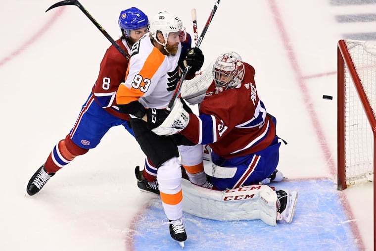Flyers right winger Jakub Voracek (93) scores past Montreal goaltender Carey Price as the Canadiens' Ben Chiarot (8) defends during the first period Sunday.