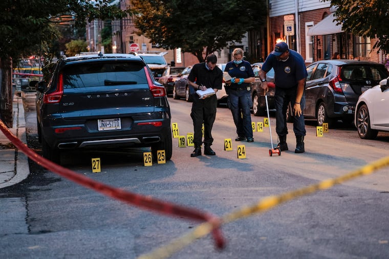 Police on the scene of a shooting at the 900 block of South Third Street, where two 19-year-old men were shot, one fatally. Over 83 spent casings were found at the scene.