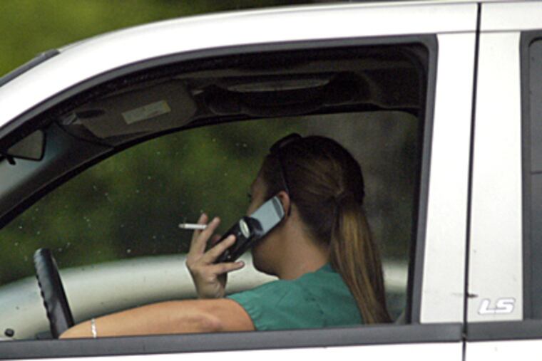 Unidentified driver talks on cell phone at traffic light on the Collingswood / Westmont border. (Tom Gralish / Inquirer)