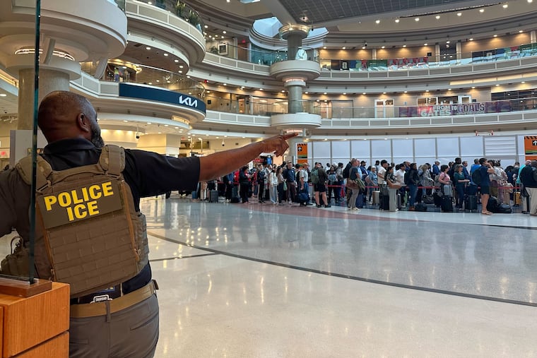 A federal immigration agent is seen as people wait in a TSA line at the Hartsfield-Jackson Atlanta International Airport, Monday, March 23, 2026, in Atlanta.