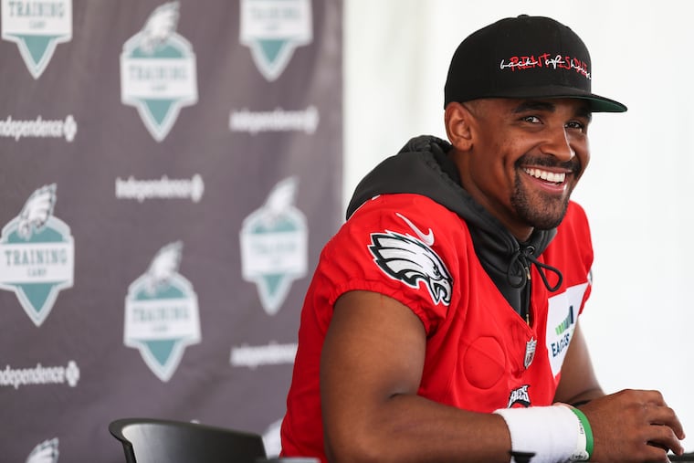 Eagles quarterback Jalen Hurts talks with reporters after a training-camp workout at the NovaCare Complex on Monday.