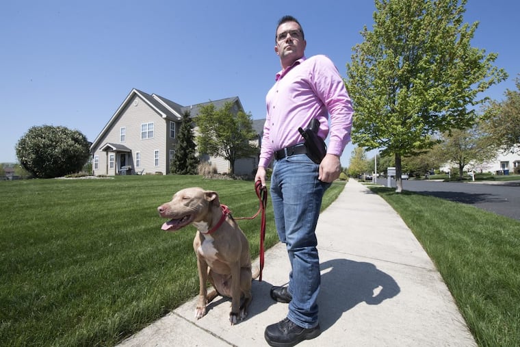 Mark Fiorino is photographed with an open-carry handgun during a walk with his dog " Barrett " in Allentown, Pa. Wednesday, May 9, 2018.