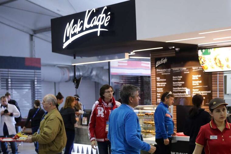 Athletes and coaches visit a McDonald's inside the Olympic Village dining hall in Sochi.