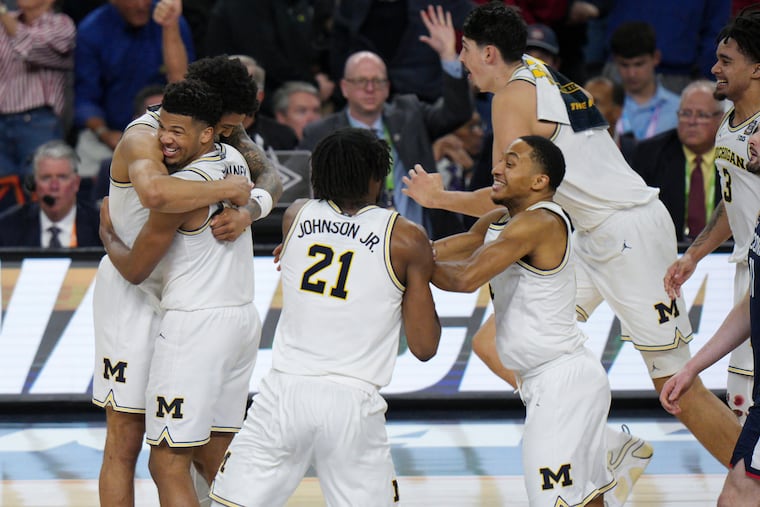 Michigan celebrates after defeating UConn in the national championship game on April 6.
