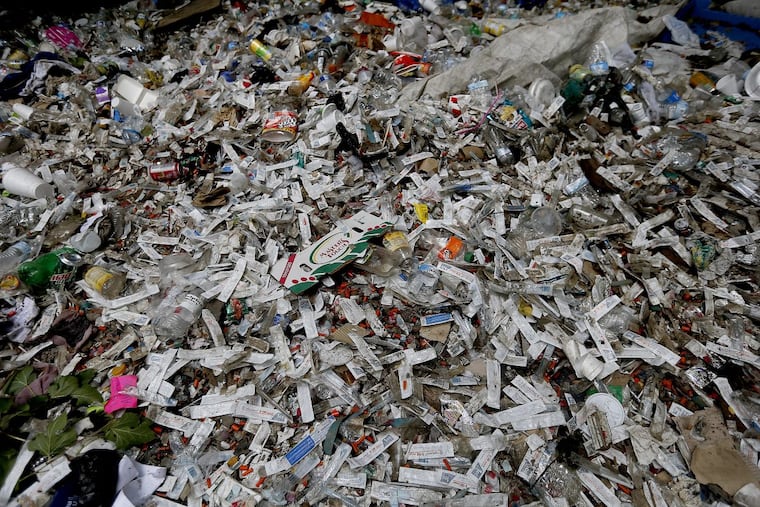 Packaging for syringes litter the ground near the Conrail railroad tracks at Second and Indiana Streets.