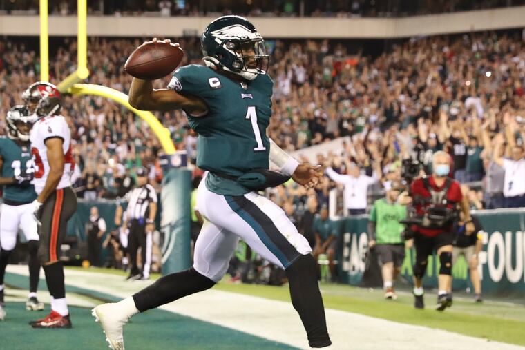 Eagles quarterback Jalen Hurts holds-up the football after scoring a third quarter touchdown run against the Tampa Bay Buccaneers on Thursday, October 14, 2021 in Philadelphia.