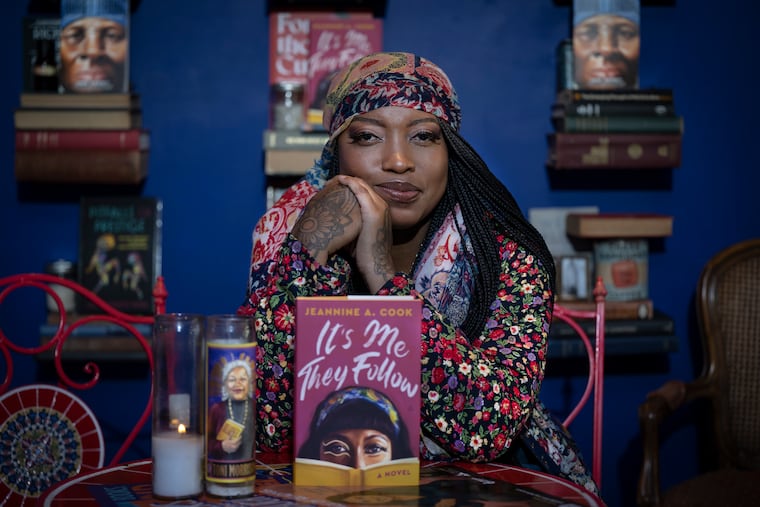 Author Jeannine A. Cook with her book at the newly refurbished Harriett's Bookshop in Fishtown.