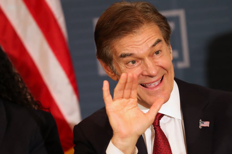 Mehmet Oz waves as he enters a roundtable discussion in South Philadelphia on Oct. 13.