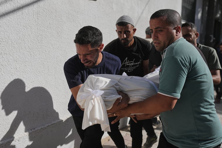 Relatives carry the body of Shadi Abu Sweilem, who was killed in an Israeli airstrike, during his funeral at Al-Shifa Hospital in Gaza City Sunday, June 14, 2026.