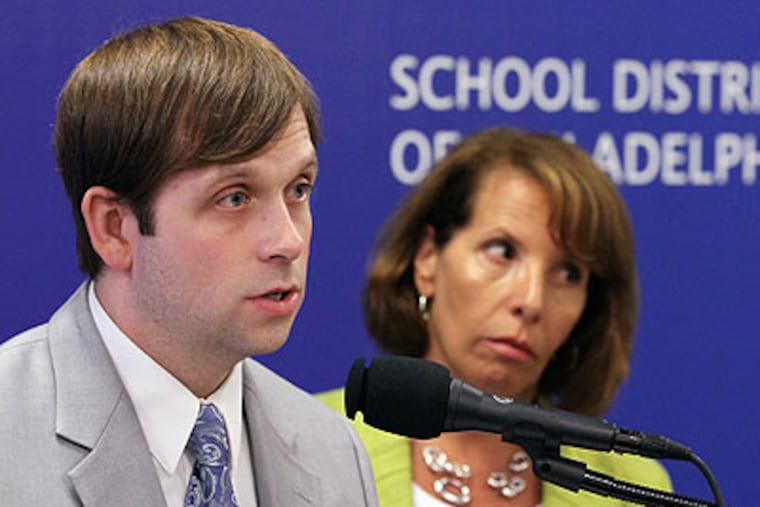 Daniel Piotrowski, executive director of Accountability and Assessment (left), and Francis Newburg, deputy chief of Accountability and Educational Technology (right), answer questions from the media after a press conference to release the Philadelphia School District's findings about test cheating in their schools. (Michael Bryant / Staff photographer)
