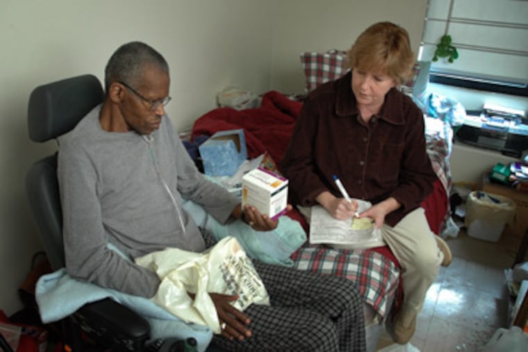 Thomas Tucker Sr reviews some of his prescription medication with his visiting nurse Mary Beth Hardiman. (Laurence Kesterson / Inquirer)