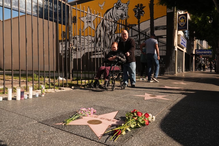 Flowers cover the Walk of Fame star for Rob Reiner Monday, Dec. 15, 2025, in the Hollywood section of Los Angeles. (AP Photo/Damian Dovarganes)