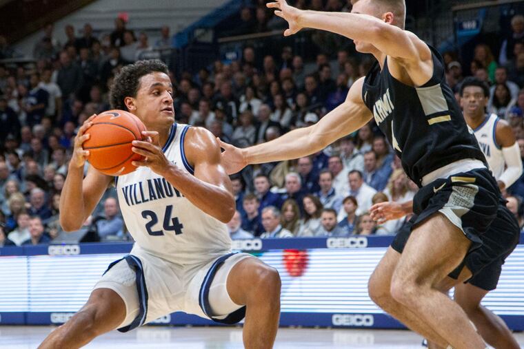 Villanova forward Jeremiah Robinson-Earl moves around Army forward Chris Mann (4) during the first half.