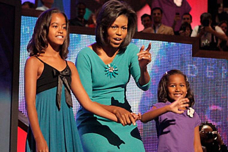 Michelle Obama, wife of Democratic presidential candidate, Sen. Barack Obama, D-Ill., and daughters Malia, left, 10, and Sasha, right, 7, wave to the audience the Democratic National Convention in Denver, Monday, Aug. 25, 2008. (AP Photo/Jae C. Hong)