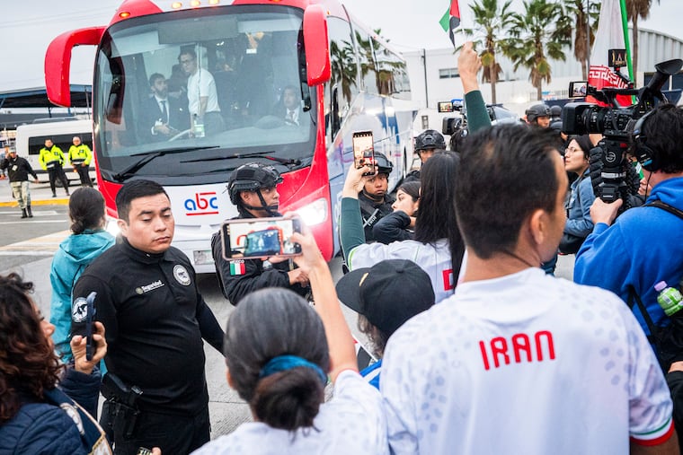 Maryam Galavi (left) and Sedagh Galavi film and cheer at the arrival of the Iran men’s soccer team in Tijuana, Mexico, on Sunday.