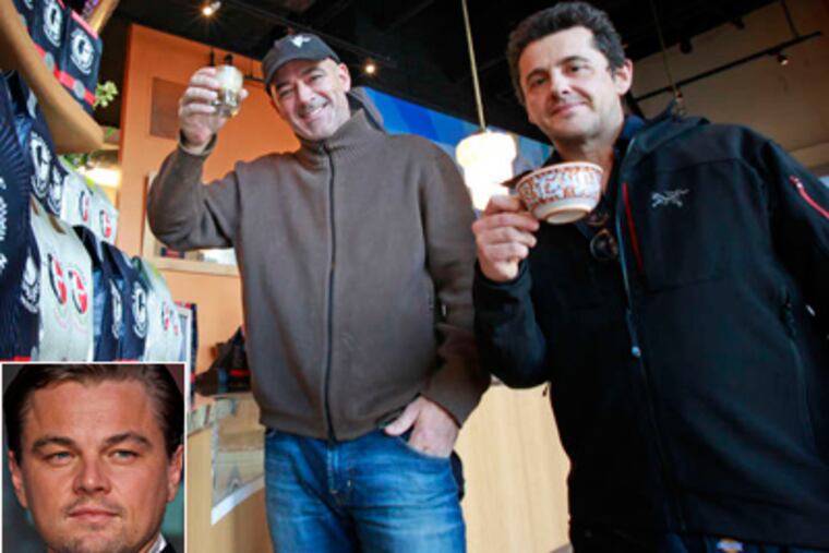 La Colombe's Todd Carmichael (center) and Jean-Philippe Iberti with their wares. "If you're a coffee roaster or you're an A-lister . . . your worlds are going to come together," Carmichael says of their new blend bearing the approval of Leonardo DiCaprio (left).