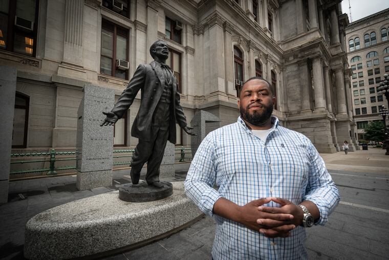 Brandon Evans in front of the Octavius V. Catto memorial outside Philadelphia City Hall.