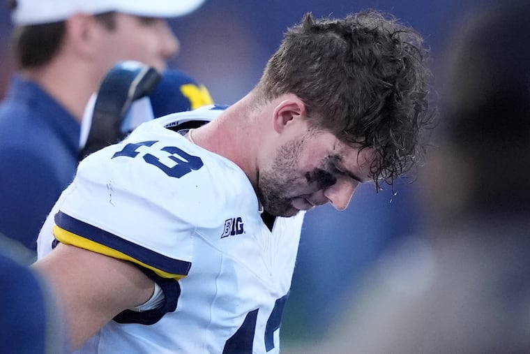 Michigan quarterback Jack Tuttle stands on the sideline in the closing minutes of the team's 21-7 loss to Illinois on Oct. 19.