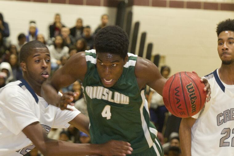 Winslow's Emmanuel Lowe (center) drives through Timber Creek's Dylan Johnson (left) and Maurice Murray (right) during a S.J. Group 3 semifinal game at Timber Creek High School in Sicklerville, NJ.