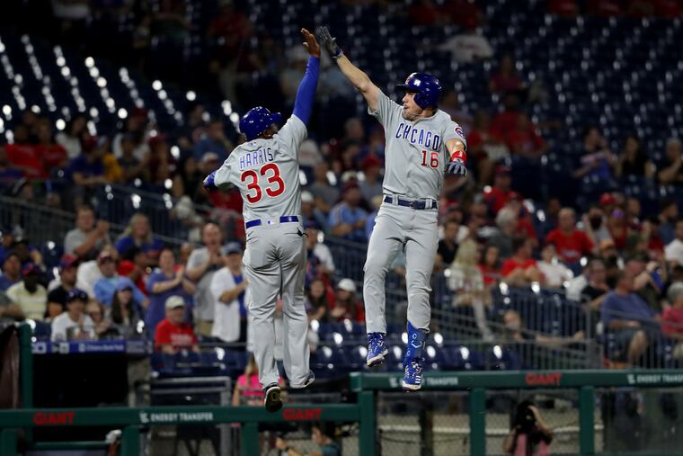 Patrick Wisdom, right, high-five’s thrid base coach Willie Harris of the Cubs after hitting a 2-run home run off of Kyle Gibson of the Phillies in the 5th inning on Sept. 14, 2021.