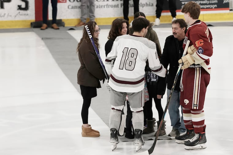 The Gaudreau family (facing camera) greets a St. Peter’s Prep captain (left) and Gloucester Catholic ice hockey captain Declan Morris (right) before their game against St. Peter’s Prep at the Hollydell Ice Arena in Sewell, N.J. on Thursday, February 6, 2025. The Gloucester Catholic team honored the legacy of the Gaudreau brothers before their game.