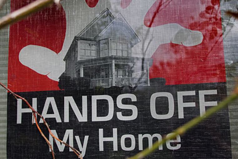 Mount Holly is wrong to knock down rundown homes without properly providing for residents. The sign in the window of Nancy Lopez's Mount Holly Gardens home says it all. (David M Warren / Staff Photographer)