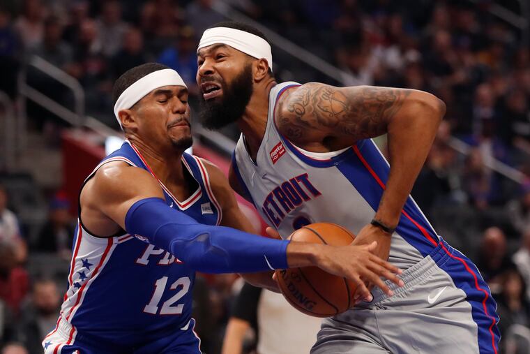 76ers forward Tobias Harris (12) reaches in on Detroit Pistons forward Markieff Morris in the first half.