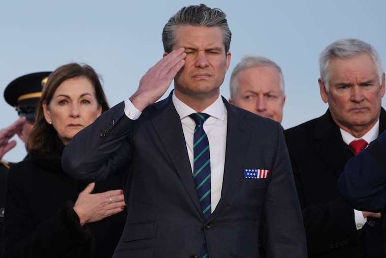 Defense Secretary Pete Hegseth salutes during a casualty return for Iowa National Guard soldiers Sgt. William Nathaniel Howard, 29, of Marshalltown, Iowa, and Sgt. Edgar Brian Torres-Tovar, 25, of Des Moines, Iowa, and civilian interpreter Ayad Mansoor Sakat, who were killed in Syria, Wednesday, Dec. 17, at Dover Air Force Base, Del.