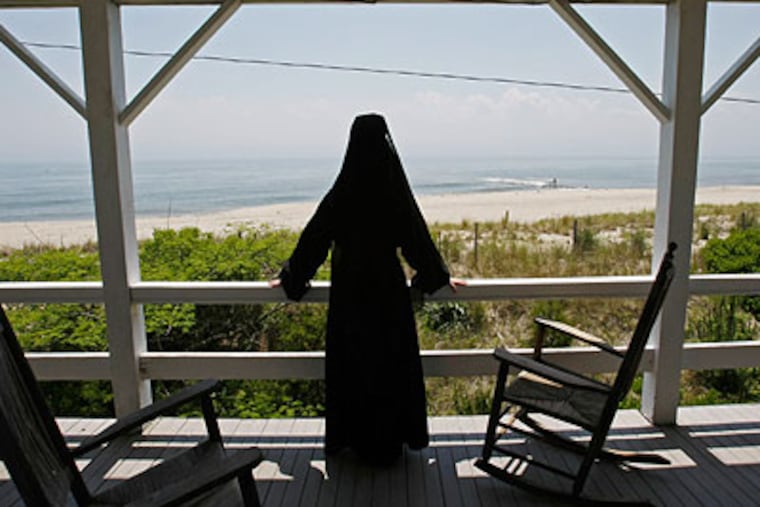 Sister Peg Conboy of the Sisters of Saint Joseph models the type of habit worn in 1909 and views the ocean from a second story porch. (Michael S. Wirtz / Staff Photographer)