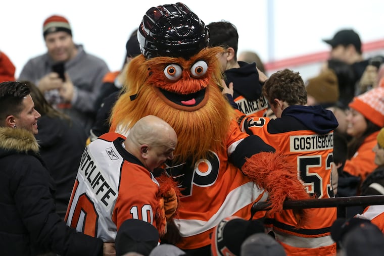In a "before" pic from January, Flyers' mascot Gritty with fans at the Wells Fargo Center. Gritty's "Queer Eye" makeover is now playing on YouTube.