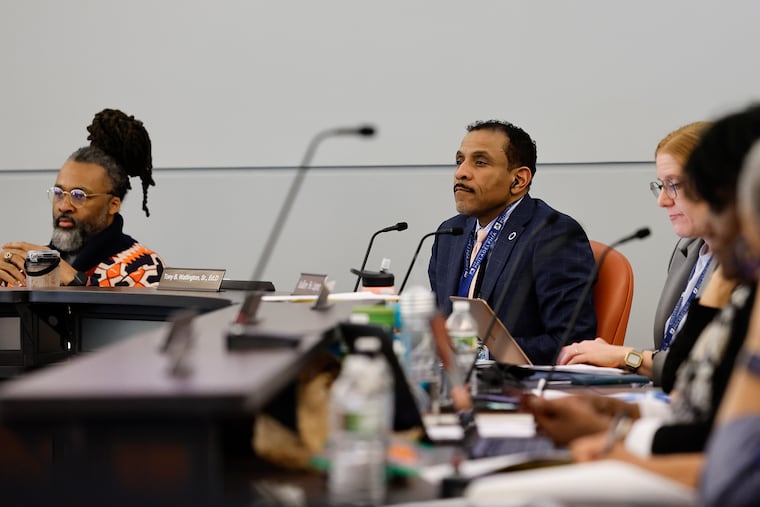 Superintendent of the School District of Philadelphia Dr. Tony B. Watlington (center) and board President Reginald L. Streater (left) listen to speakers during a board meeting on Feb. 29, 2024.