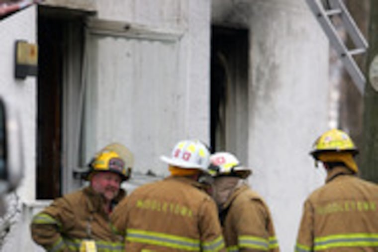 Firefighters outside the scene of a blaze that killed Lt. Nicholas Picozzi Jr. in Upper Chichester. No one was home at the time the fire broke out, though the homeowners' dog was killed. The cause of the fire has not been determined.