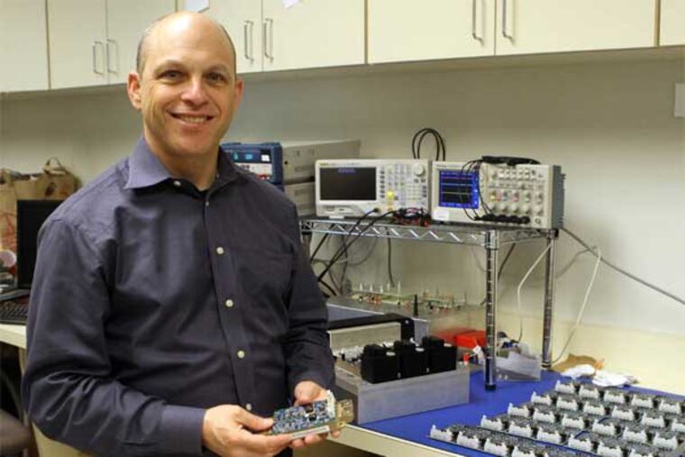 Rob Weber, CEO of AgileSwitch LLC, holds a switch created by his company that converts useful energy from renewable sources in Philadelphia, on Wednesday, June 19, 2013. (Stephanie Aaronson / Staff Photographer)