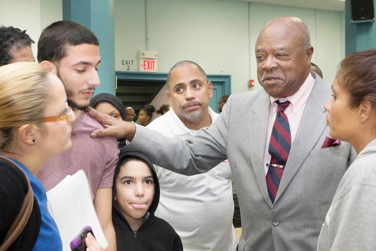 At Walter Palmer Charter High School, on October 27, 2014, founder Walter Palmer consoles students and parents at an emergency meeting to discuss other options for the nearly 300 displaced students. Palmer was ordered to reduce enrollment to 675 students due to funding restrictions. Chanda Jones / Staff Photographer
