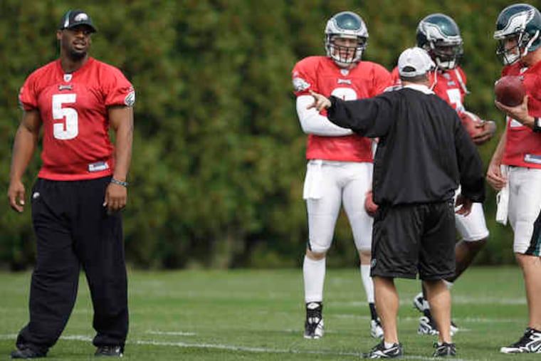 Eagles quarterbacks coach James Urban talks with Kevin Kolb (right), who was joined by (from left) Donovan McNabb, Jeff Garcia, and Michael Vick.