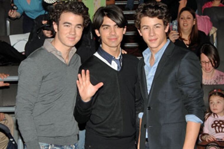 From left, musician's Kevin Jonas, Joe Jonas and Nick Jonas make a
surprise theater visit to promote their new movie "Jonas Brother's: 3D
Concert Experience", in Westchester, New York, on Saturday. (AP Photo / Peter Kramer)